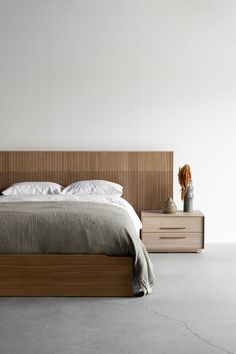 a large bed sitting next to two nightstands on either side of the headboard