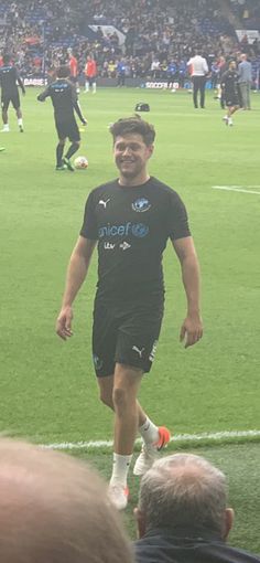 a man standing on top of a soccer field