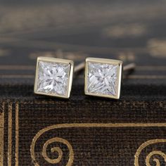 Perfect pair of princess cut diamonds, set on hand-crafted bezels. The rich 18kt yellow gold contrasts beautifully against the white diamonds. They sit low on the lobes, yet pack up tons of sparkle! Diamond Measure 5.03 x 5.02 x 3.55 mm & 5.02 x 5.02 x 3.63 mm GIA links here & here Modern Mens Rings, Art Jewelry Earrings, Antique Watches, Pack Up, Princess Cut Diamond, Antique Engagement, Mens Band, Vintage Band, Bezel Diamond