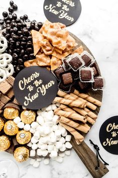 a platter filled with chocolates, pretzels, and other treats for new year's eve