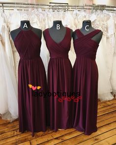 three bridesmaid dresses on mannequins in a store