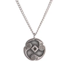 a silver necklace with an intricate design on it