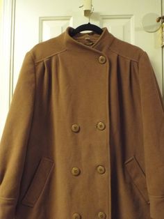 "Women's cashmere blend 1980s vintage trendy long coat by Miss Smith. Stay warm and toasty with this preppy vintage coat on those chilly winter days. It is a nice warm mocha brown color. This vintage coat is a size 14, with big button and two front pockets. There is a small worn spot please see the photo. It is made of wool, and cashmere. Soft not itchy at all. Size 14 US UK 16 42\" bust 46\" waist 44\" hips 17\" shoulder to shoulder 33\" middle of neck to hem of sleeve 45\" middle of neck to bo Single Breasted Brown Pea Coat For Winter, Brown Single-breasted Pea Coat For Winter, Brown Buttoned Outerwear For Winter, Brown Long Pea Coat For Winter, Brown Buttoned Outerwear For Cold Weather, Brown Pea Coat For Winter, Brown Pea Coat For Cold Winter Weather, Brown Long Pea Coat For Cold Weather, Brown Winter Pea Coat For Cold Weather