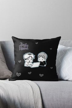 a black and white pillow with two cartoon characters on it, one holding the other's head