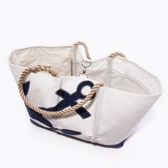 two white and blue handbags with rope handles on each side, one in the shape of an anchor