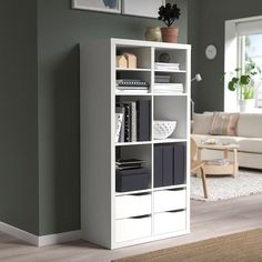 a living room with a white bookcase filled with books