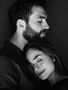 a black and white photo of a man with his eyes closed next to a woman