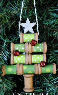 wooden spool christmas tree ornament hanging on a christmas tree with text overlay