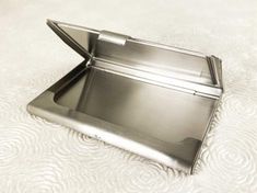 an empty metal tray sitting on top of a white surface