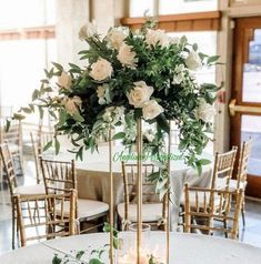 the centerpieces are decorated with white roses and greenery