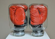 two glass jars with boxing gloves in them