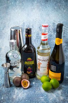 bottles of alcohol and limes on a table