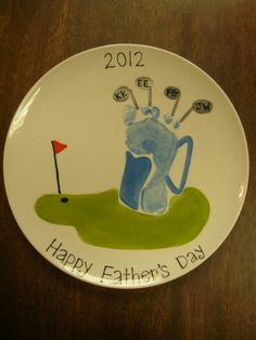 a plate with a drawing of a golf player holding a flag and the words happy father's day written on it