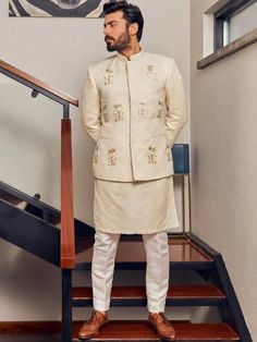 <p>Color: Off-White<br />Fabric: Jamawar<br />Stylish prince coat features rich quality embellishments accentuate on the front<br />Hidden front hooks closure<br />Complement with matching kurta and pajama</p> <p> </p> <p><strong>Additional Accessories:</strong> </p> <p><strong>Plain Kolhapuri/Saleem Shahi shoes:</strong> US$30 (Made with prince coat material)</p> <p><strong>Note:</strong> Price of all prince coat suits includes only 3 pieces i.e. prince coat, kurta/kameez and shalwar/pajama (or Designer Cream Nehru Jacket For Festive Season, Wedding Embroidered Sets With Stand Collar, Embroidered Wedding Sets With Stand Collar, Formal Embroidered Nehru Jacket Straight Kurta, Designer Cream Nehru Jacket, Ceremonial Cream Nehru Jacket For Festive Occasions, Festive Cream Nehru Jacket For Ceremonial Occasions, Designer Straight Kurta Sets For Wedding, White Festive Suits With Zari Work