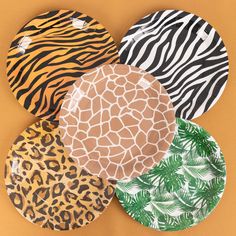 four paper plates with animal print designs on them, all in different shapes and sizes