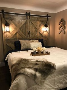 a bedroom with a large bed and wooden headboard made out of wood planks