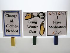 three signs are hanging on the wall with clothes pins attached to them that say change of clothes and have winter medical gear