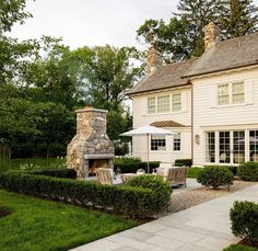 a large white house with a stone fireplace