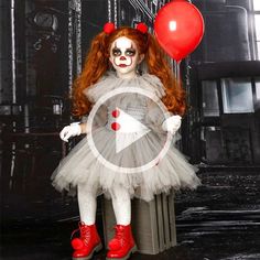 a woman dressed as a clown with red hair and makeup holding a balloon in front of her face