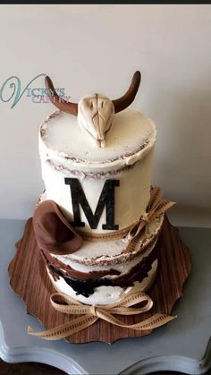 the cake is decorated with white frosting and brown ribbon around it's edges