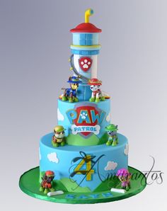 a toy story themed cake with characters on the top tier and an animal tower in the background