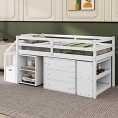 a white bunk bed with drawers underneath it on carpeted floor next to green wall