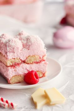 two pieces of cake on a plate with raspberries