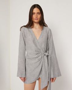 Designed in a mini crossover silhouette, this Air Linen Wrap Dress is cut from a breezy linen blend, with wide sleeves and a functional side tie. Spring Day Out Linen Mini Dress, Chic Long Sleeve Wrap Dress For Beach, Chic Beach Dresses With Side Ties, Spring Brunch Wrap Dress, Linen Mini Dress With Tie Back For Day Out, Spring Wrap Mini Dress With Tie Waist, Spring Daywear Linen Mini Dress, Spring Linen Mini Dress For Daywear, Spring Linen Mini Dress With Tie Back