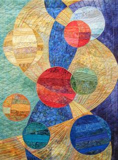 a quilted wall hanging with circles on it