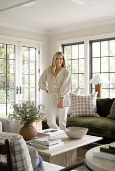 a woman is standing in the living room