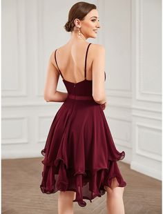 the back of a woman wearing a burgundy dress