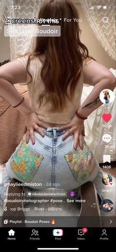 a woman with her back to the camera and showing off her tattoo on her jeans