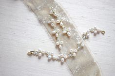 "Featuring a gorgeous combination of crystals and freshwater pearls, this bracelet and earrings set is the perfect piece to add to your bridal look for a touch of vintage meets modern glam! - Bracelet measures 6\" x 0.5\" - Earrings measure 2.5\" x 0.5\" - Made with high quality cubic zirconia and freshwater pearls - Available in rose gold, yellow gold and rhodium (silver) finishes Browse My Entire Shop For More Jewelry & Accessories: https://www.etsy.com/shop/TheExquisiteBride Browse My Sho Elegant Wedding Jewelry Sets With Bracelet Shape, Elegant Wedding Jewelry Sets With Bracelets, Wedding Elegant Jewelry Sets With Bracelet, Elegant Wedding Jewelry Sets Including Bracelet, Rose Gold Bracelets With Pearl Charm For Wedding, Rose Gold Wedding Bracelets With Pearl Charm, Elegant Rose Gold Pearl Bracelet For Wedding, Delicate Pearl-embellished Jewelry For Mother Of The Bride, Dainty Rose Gold Pearl Bracelet For Wedding