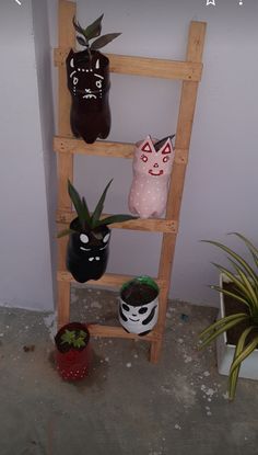 a wooden ladder with pots and plants on the top shelf, along with other decorative items