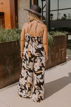 - Kick back and enjoy some vacay vibes in this stylish jumpsuit! - Unlined material with an abstract floral print - A v-cut neckline with a twist detail - Adjustable spaghetti straps - A smocked upper back with a tie detail - A wide legged jumpsuit with floor length hemlines Chic Floral Print Jumpsuits And Rompers For Beach, Chic Floral Print Beach Jumpsuit, Chic Beach Jumpsuit With Floral Print, Chic Printed Jumpsuits And Rompers For Vacation, Chic Printed Jumpsuit For Vacation, Black Printed Jumpsuits And Rompers For Beach, Black Printed Jumpsuit For Beach, Black Floral Print Jumpsuits And Rompers For Vacation, Chic Tropical Print Jumpsuits And Rompers For Vacation