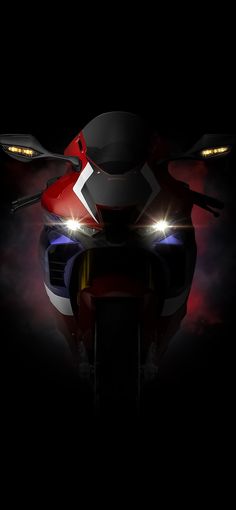 a red and white motorcycle in the dark