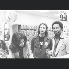 three people standing in a store looking at items