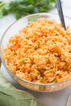 a glass bowl filled with rice and peas