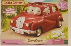 a red toy car with two stuffed animals in it