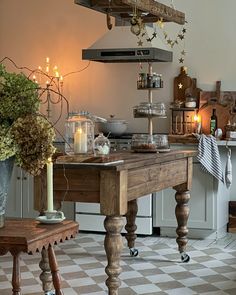 a kitchen with a table and some candles on it