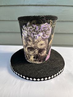 This Mini halloween mini top hat will dress up your Halloween decor or make your halloween wreath truly unique. Made from foam and fabric. This is not a sewn product only hot Glue was used so handle with a little care. I added black trim. It has a belt Around the bottom of the hat above the brim and i added a cameo. Only one available. This hat is 7 inches tall. The brim is wired so you can shape it however you want it. Direct sunlight will fade it. Check out my Facebook page Bulldogmom2 Creations and give me a like to see what I create and to check out other reviews. Halloween High Crown Top Hat For Themed Events, High Crown Top Hat For Halloween Themed Events, Themed High Crown Top Hat For Halloween, Halloween Costume Top Hat With High Crown, High Crown Top Hat For Halloween Costume, Themed High Crown Costume Hats For Halloween, Handmade High Crown Top Hat For Party, Whimsical Top Hat For Halloween Costume Party, High Crown Top Hat For Halloween