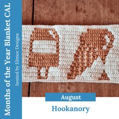 an orange and white crocheted sign on a wooden surface with the words, august hookaroy