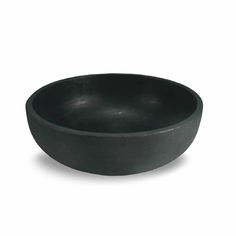 a black bowl sitting on top of a white table