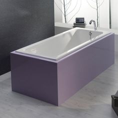 a bath tub sitting on top of a wooden floor