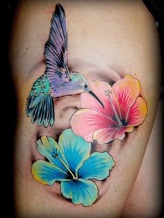 a woman's stomach with flowers and a hummingbird on it, painted in pastel colors