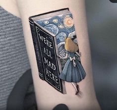 a woman with a book tattoo on her arm that says, we are all mad here