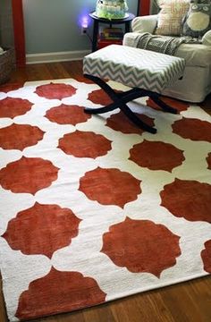 a living room with a chair and rug on the floor