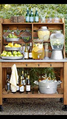 an outdoor bar cart filled with drinks and lemons