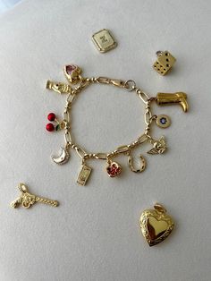 Cheap Sentimental Charm Bracelet As Personalized Gift, Luxury Dangling Charms Bracelet, Cheap Vintage Charm Bracelet Gift, Cheap Vintage Gold Charm Bracelet, Personalized Charm Bracelet For Friendship, Vintage Gold Charm Bracelet Luxury, Luxury Vintage Gold Charm Bracelet, Symbolic Gold Bracelets With Charms, Gold Plated Charm Bracelet With Removable Charms