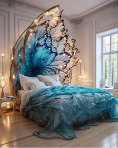 a bed with blue and white butterfly wings on the headboard, in a bedroom